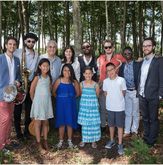 Group photo of musicians and children